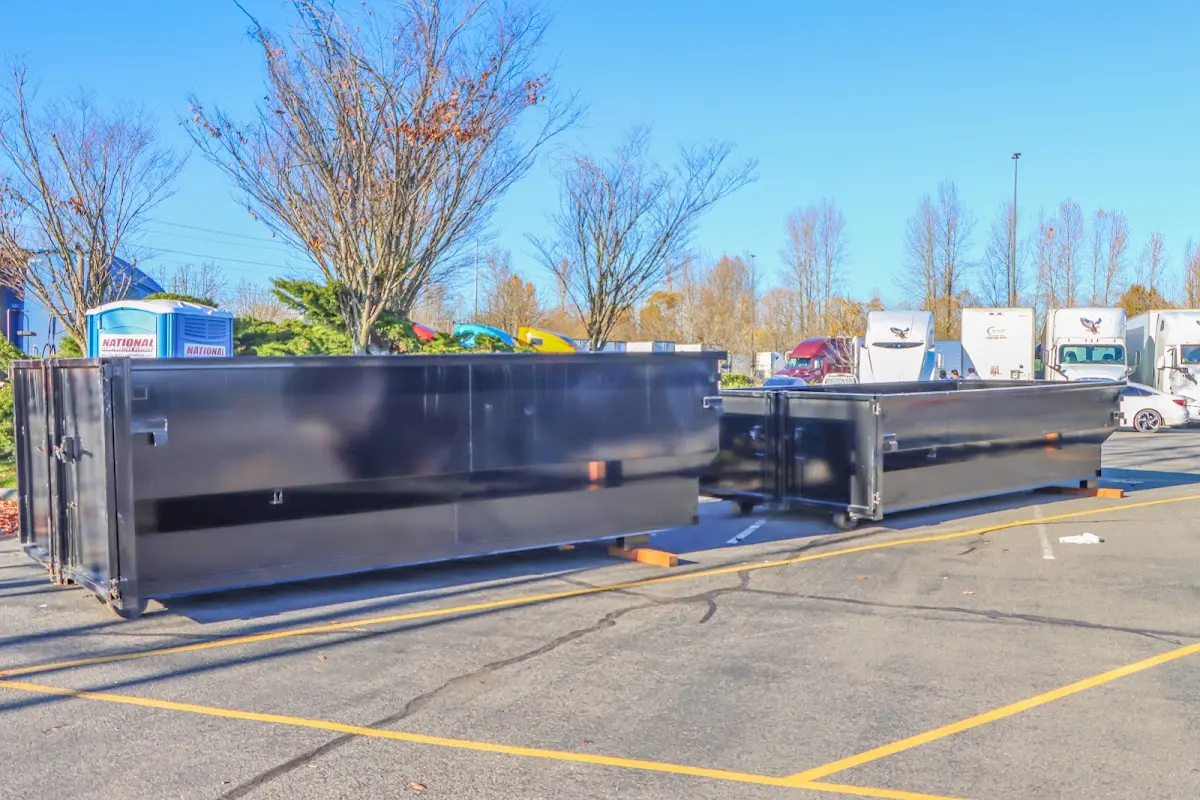 Professional dumpster rental service with roll-off container on residential driveway in Rogers